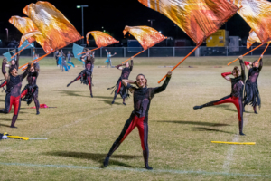 color guard on the field with orange flags